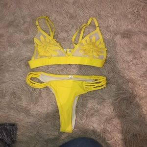 Yellow bathing suit with flower as the coverage